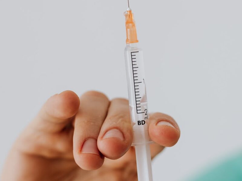 close up view of person holding a vaccine